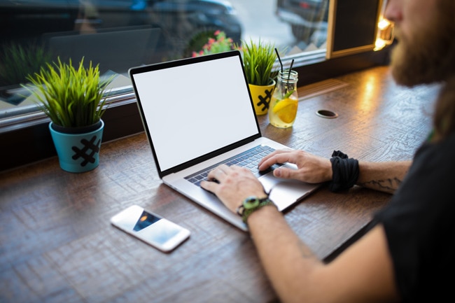 Person on laptop promoting their webinar